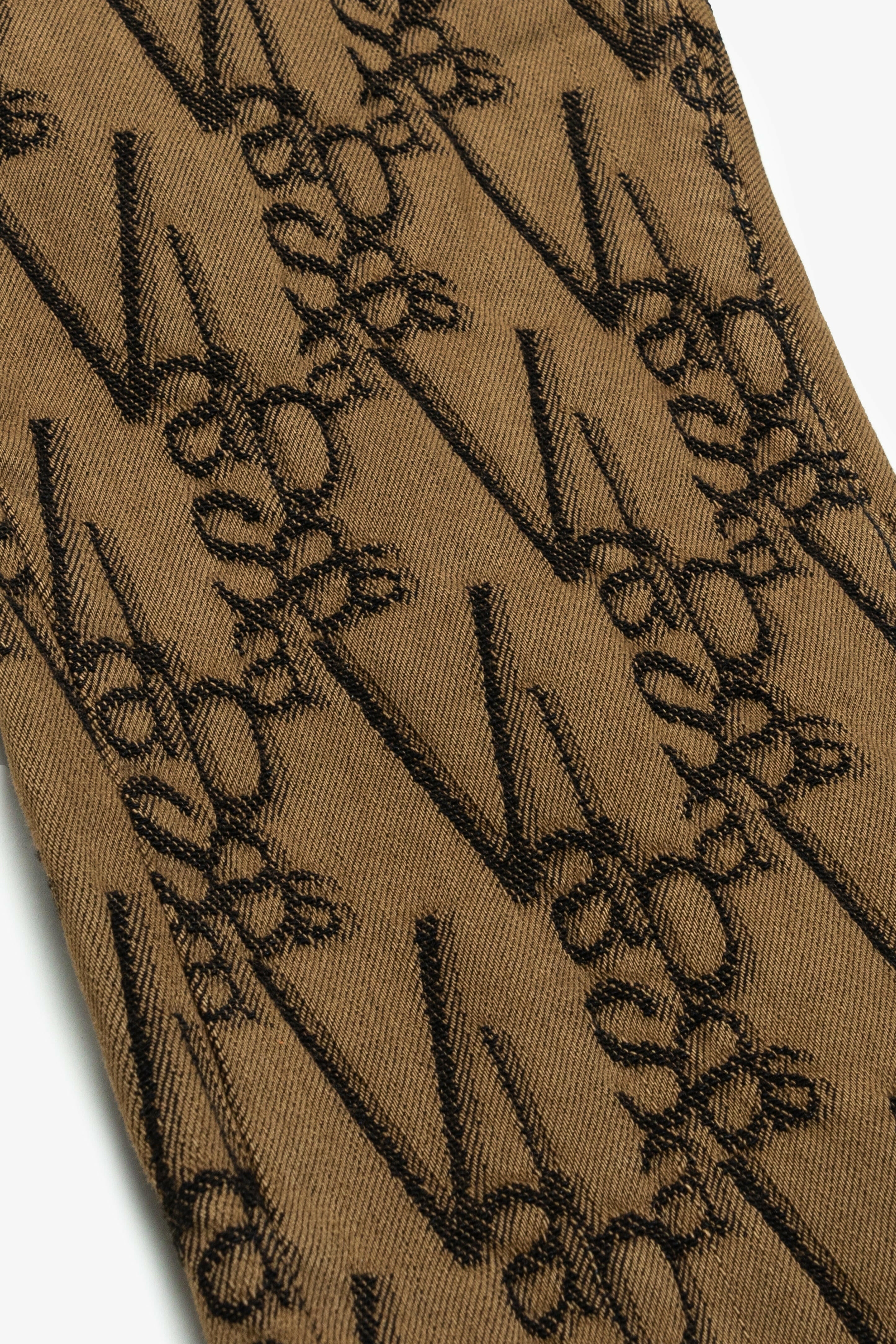 Valabasas “V-Scrawl” Stacked Flare Jean.