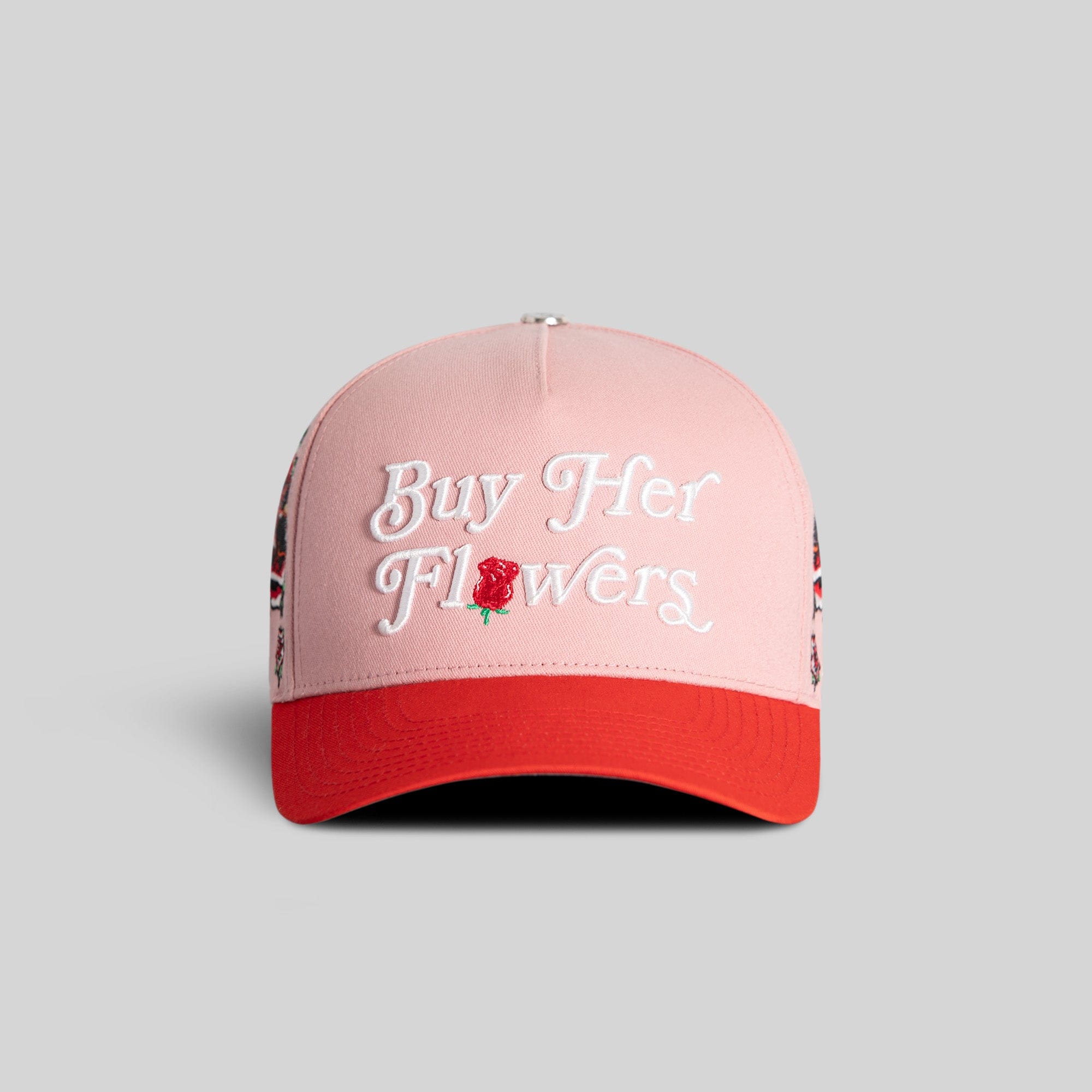 Field Grade Buy Her Flowers Rose Royce Twill Trucker hat in pink and red with a curved brim and adjustable strap.