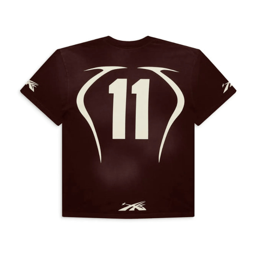 Hellstar Warm Up T-Shirt displayed on a hanger, featuring a comfortable fit and stylish design in a showroom setting.