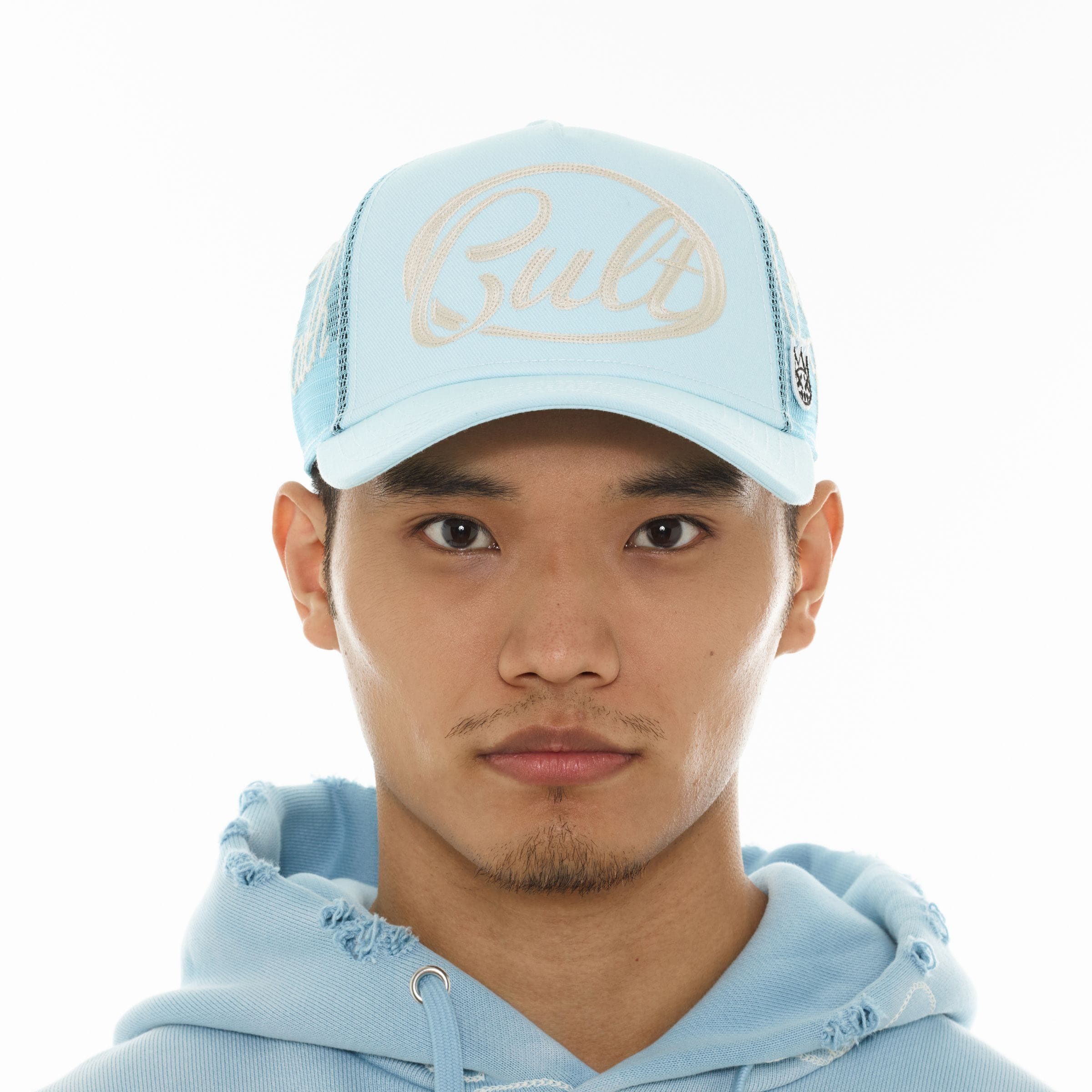 Cult of Individuality mesh back trucker hat with adjustable snap closure and embroidered logo on front panel.