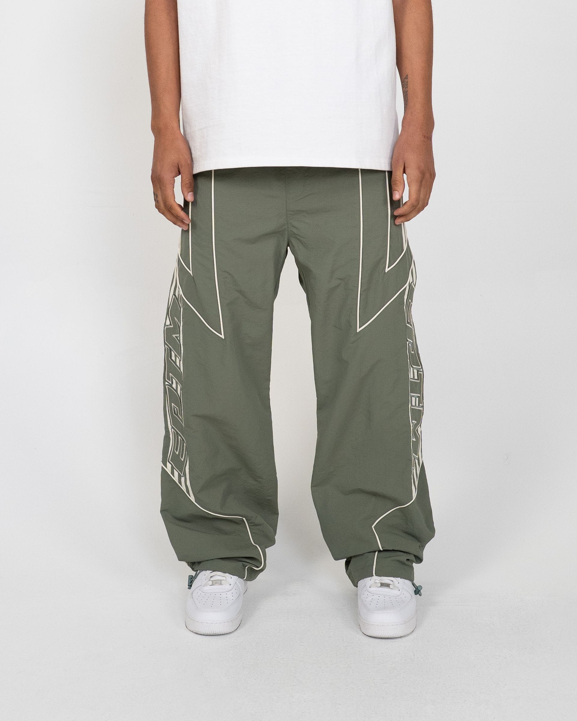EPTM Pepe track pants in black, featuring a relaxed fit with breathable fabric and stylish design, shown on a model.