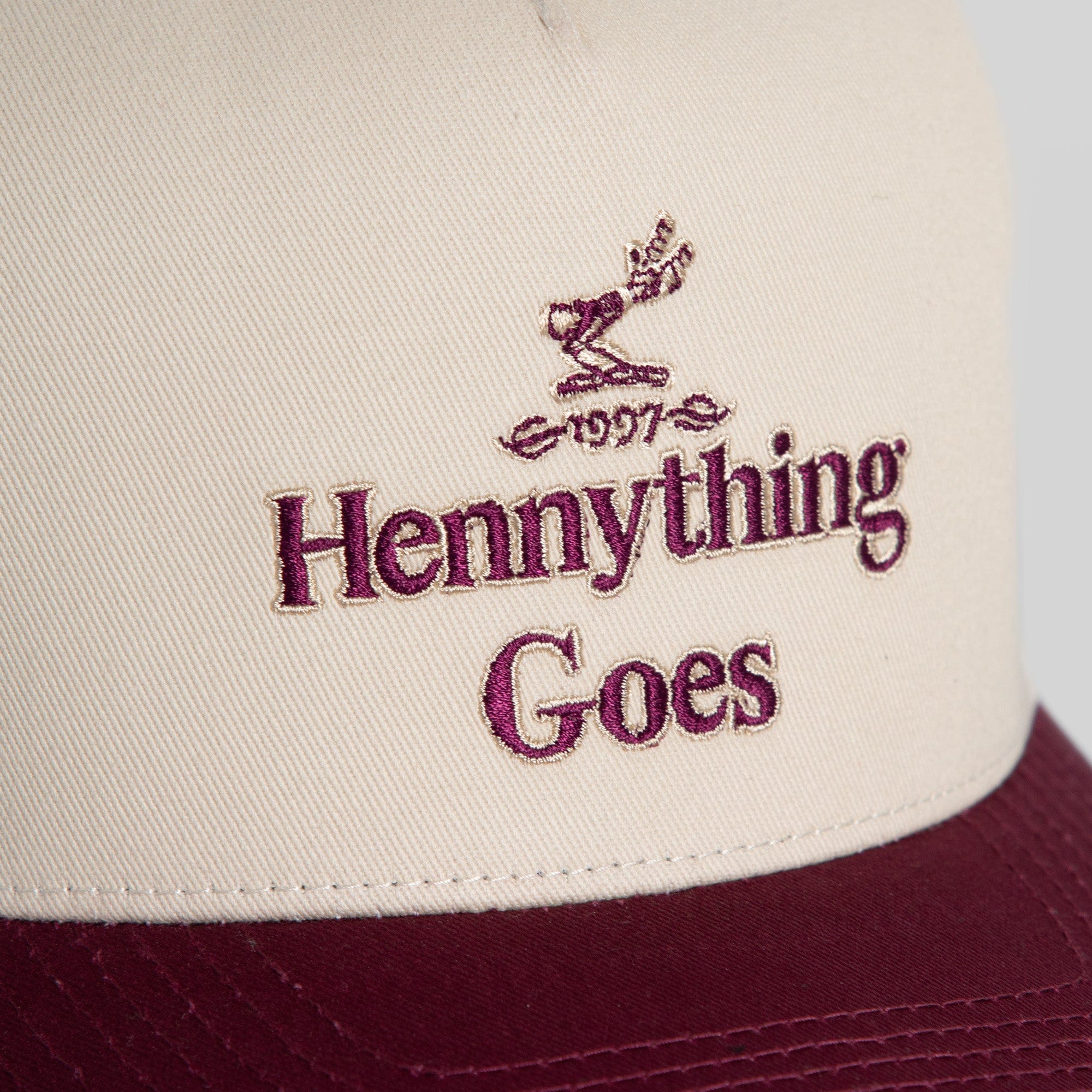 Field Grade Hennything Goes Bordeaux Twill Trucker Hat featuring a structured cap with a curved brim and adjustable snapback closure.