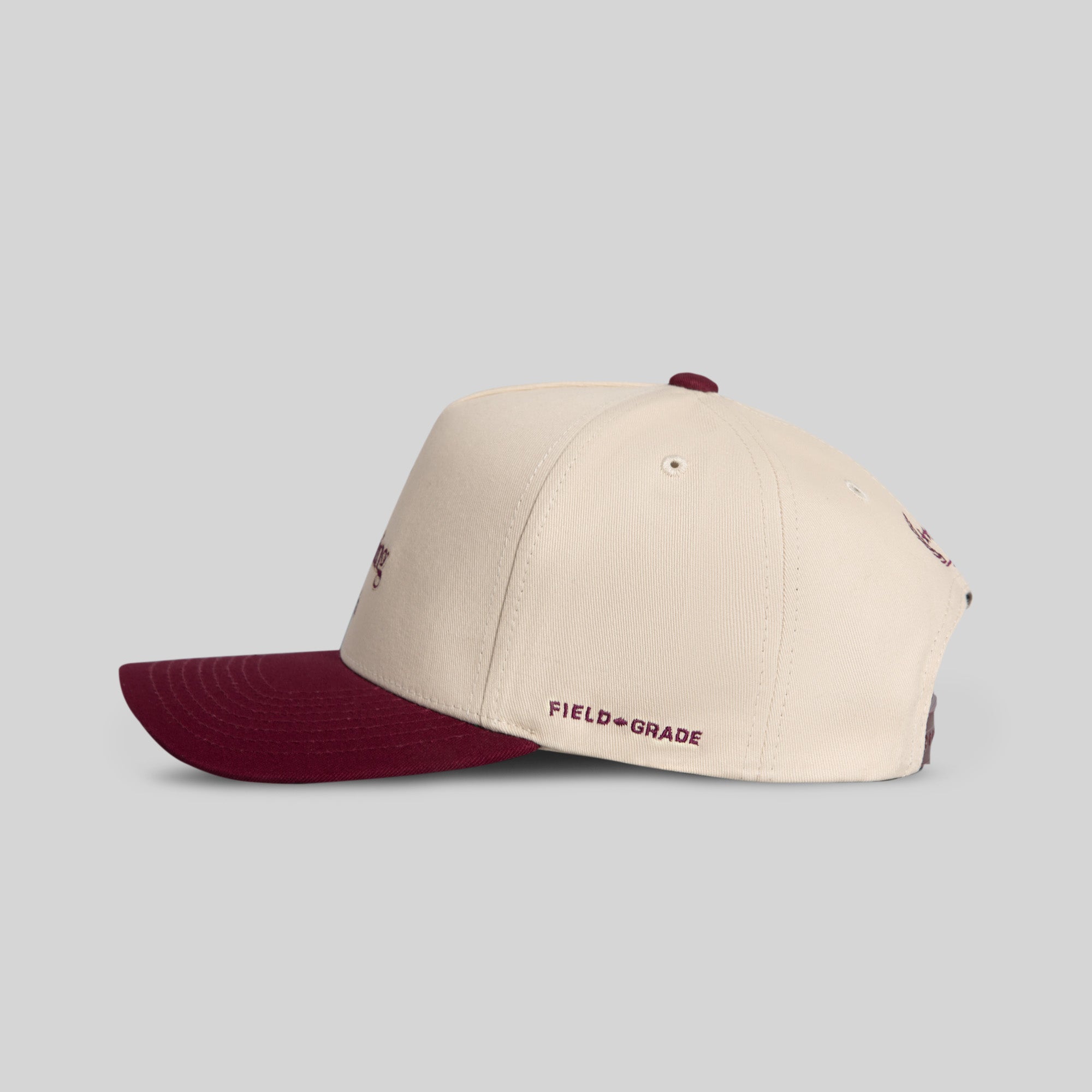 Field Grade Hennything Goes Bordeaux Twill Trucker Hat shown from side view, featuring a stylish Bordeaux twill fabric and classic trucker design.