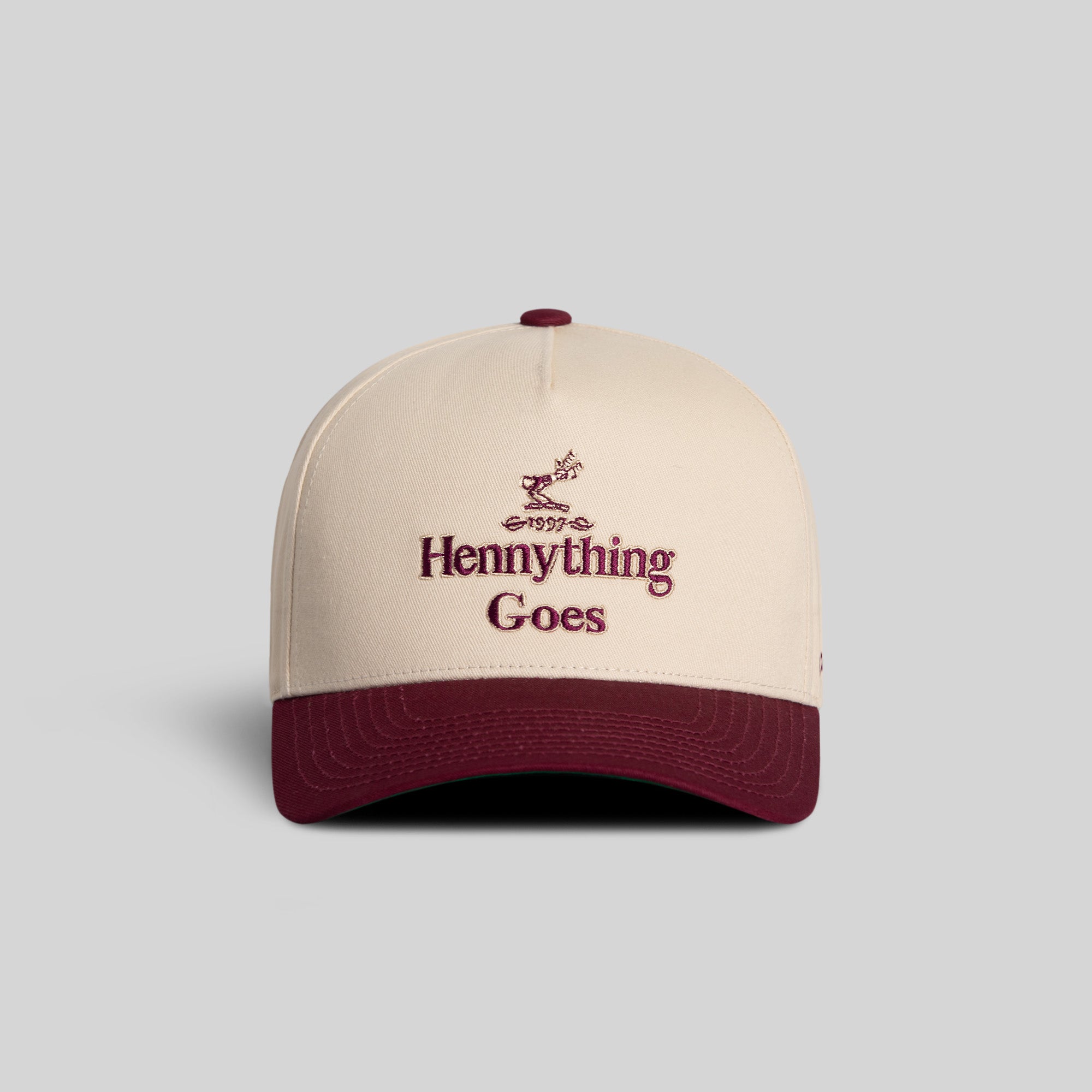 Field Grade Hennything Goes Bordeaux Twill Trucker Hat with curved brim and adjustable strap, featuring stylish embroidered logo.