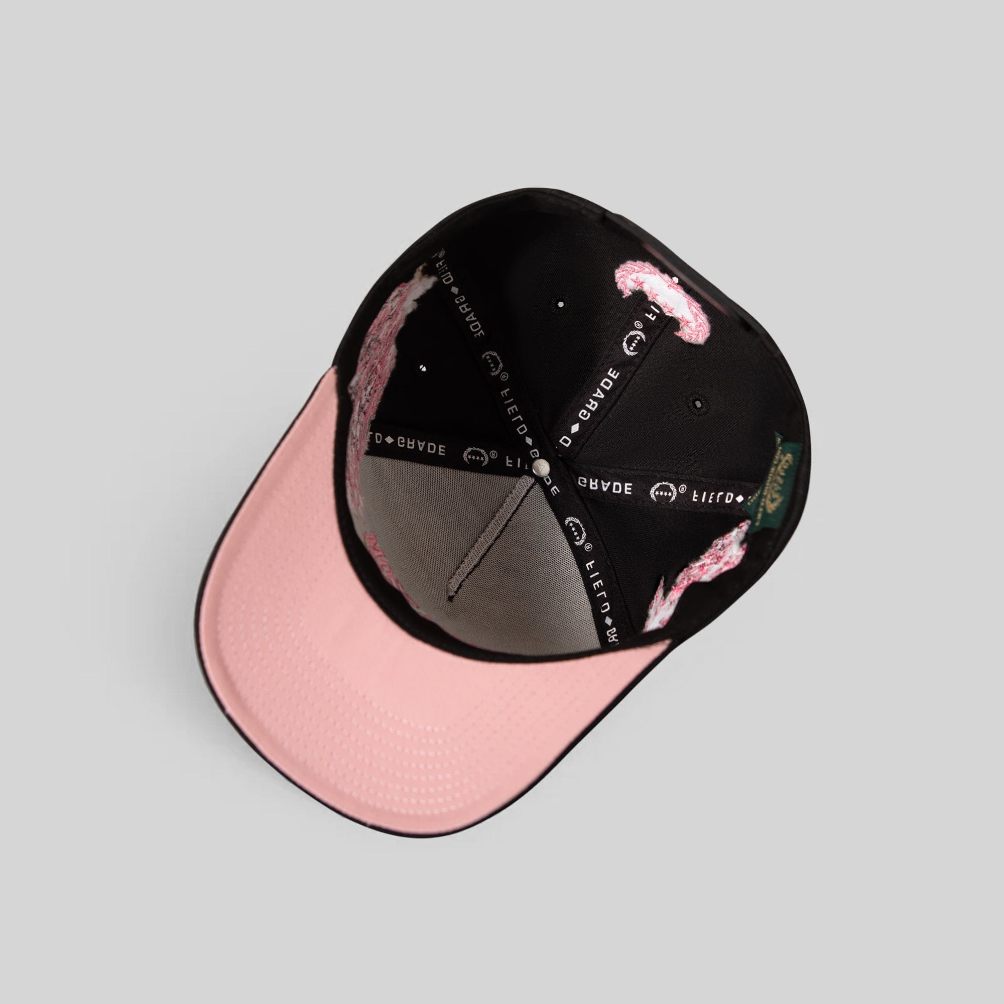 Black twill trucker hat with cherry blossom embroidery by Field Grade, featuring a structured brim and adjustable snapback.