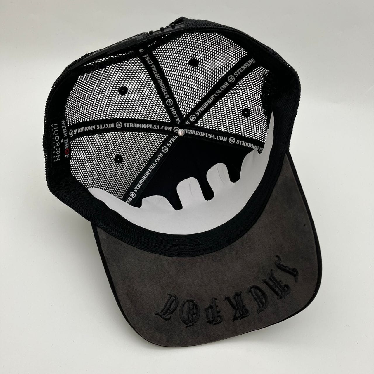Black Hudson Outerwear V2 Diamond Suede Trucker Hat with structured brim and adjustable snapback in a close-up view
