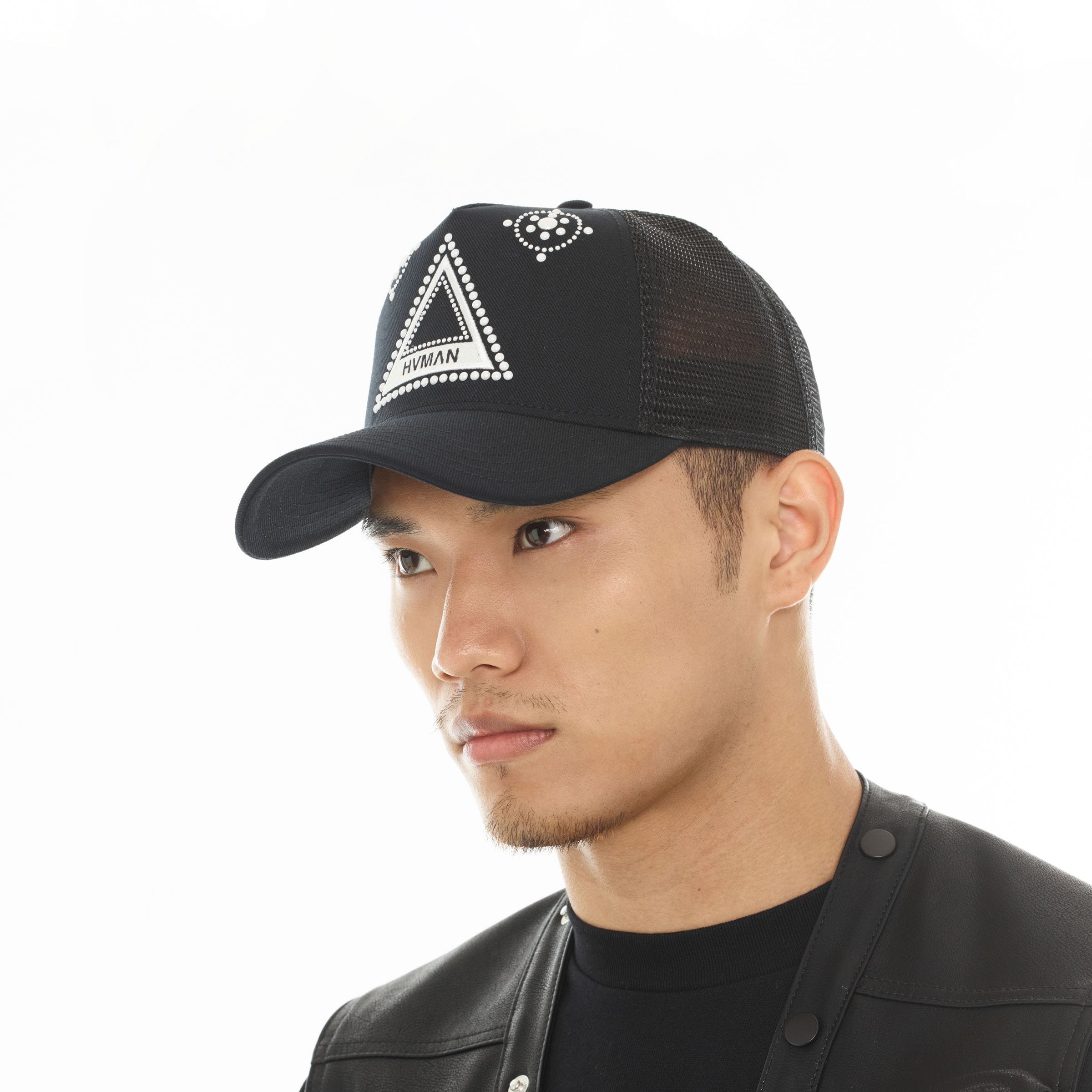 Hvman triangle logo mesh trucker hat featuring breathable mesh panels and adjustable snapback closure.