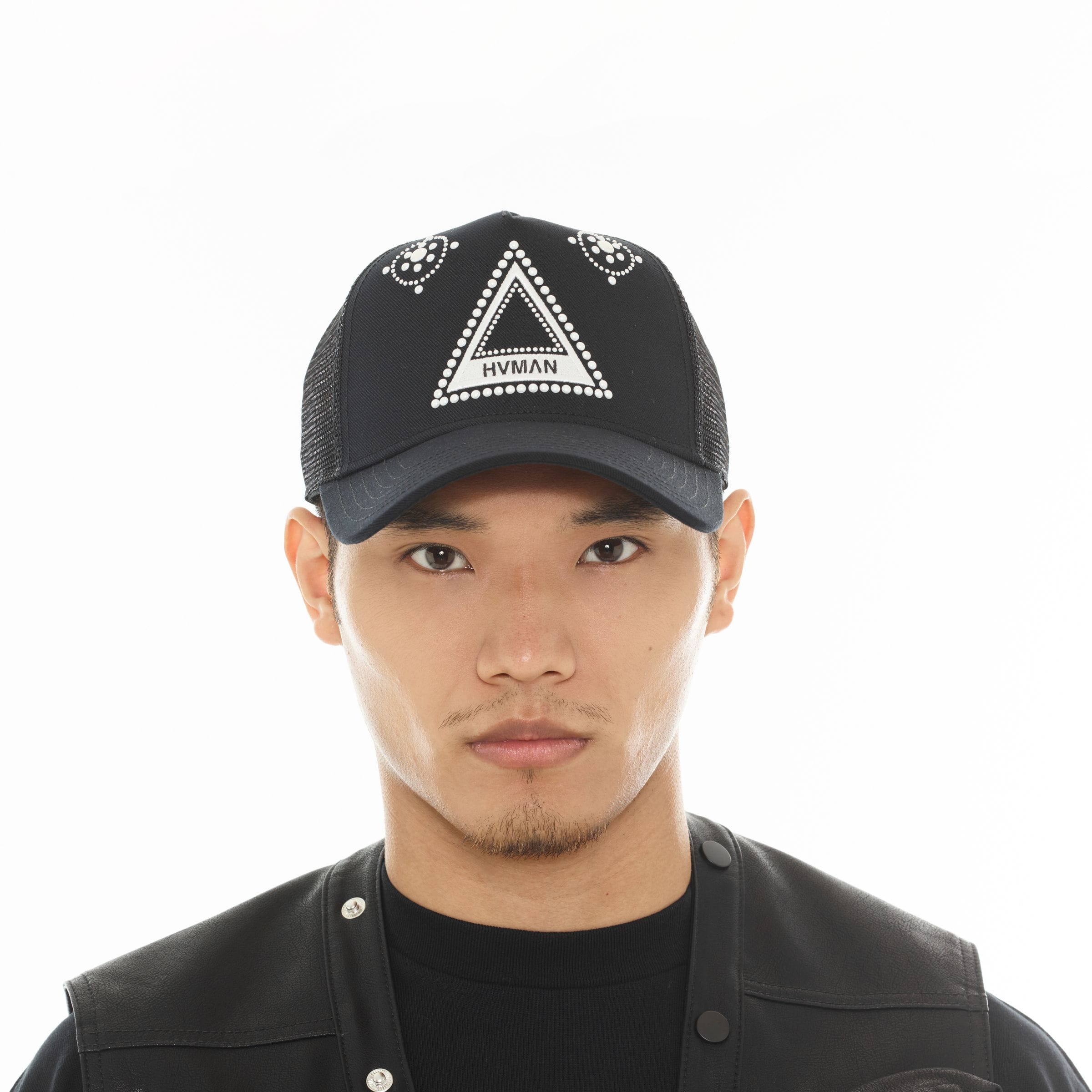 Hvman triangle logo mesh trucker hat showing a front view with adjustable snapback closure and breathable mesh panels.