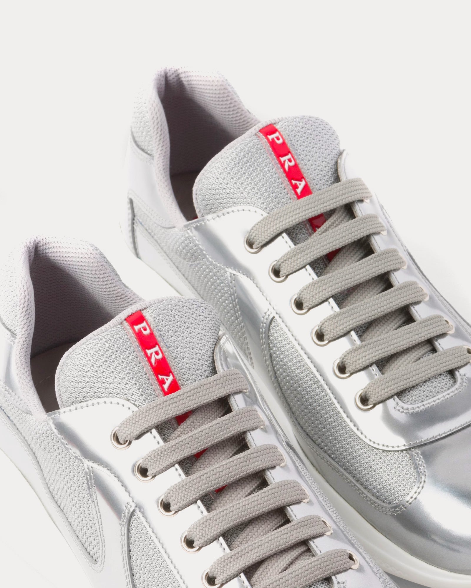 Prada America's Cup silver sneakers featuring metallic leather and bike fabric design.