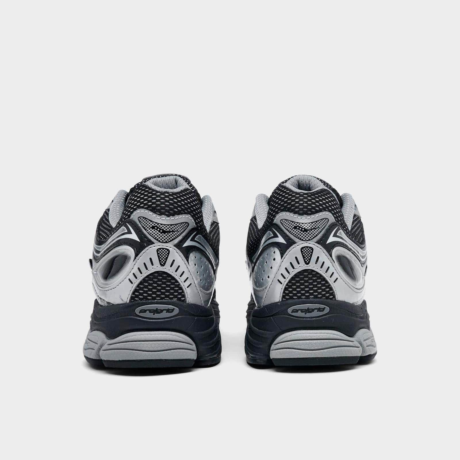 Men's Saucony ProGrid Omni 9 sneakers in black and metallic silver, featuring breathable mesh uppers and cushioned support.