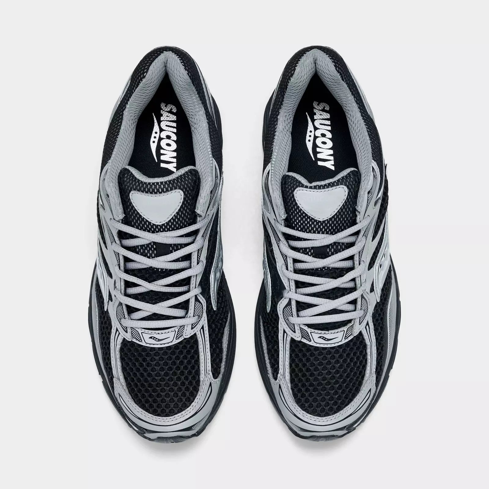 Men's Saucony ProGrid Omni 9 sneakers in black with metallic silver accents, featuring breathable mesh and supportive design.