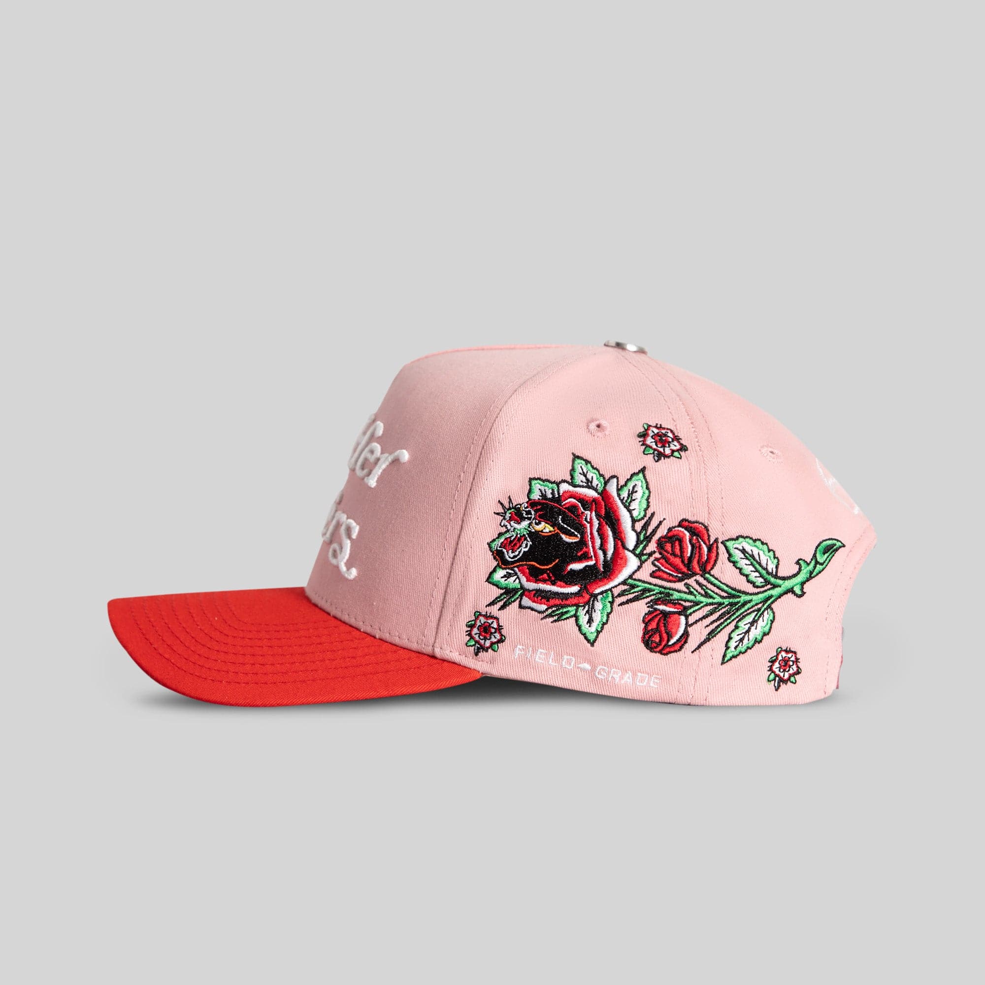Field Grade Her Flowers Rose Royce Twill Trucker Hat in pink and red with embroidered floral design on front.