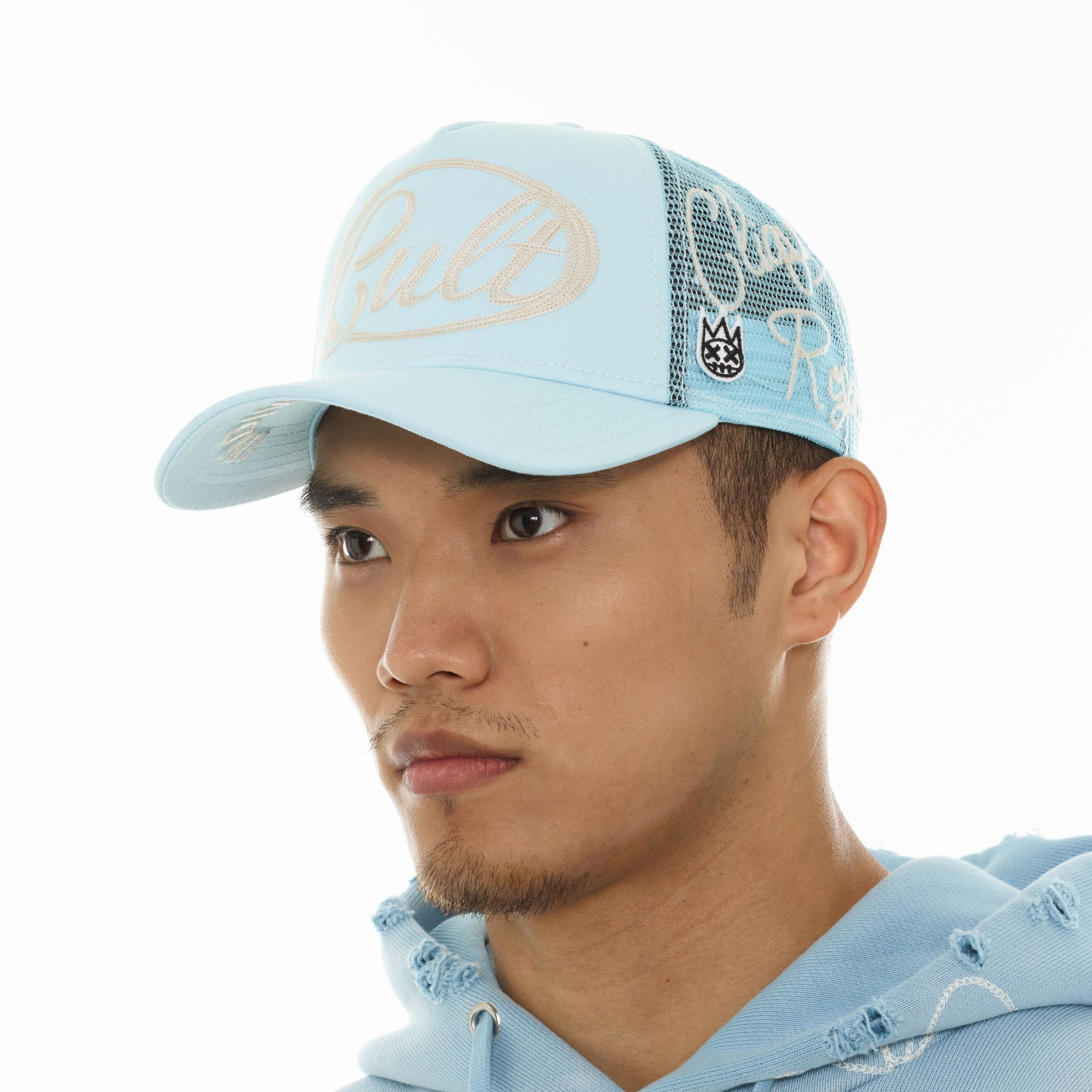 Cult of Individuality mesh back trucker hat featuring a curved brim and adjustable strap with a bold logo design.