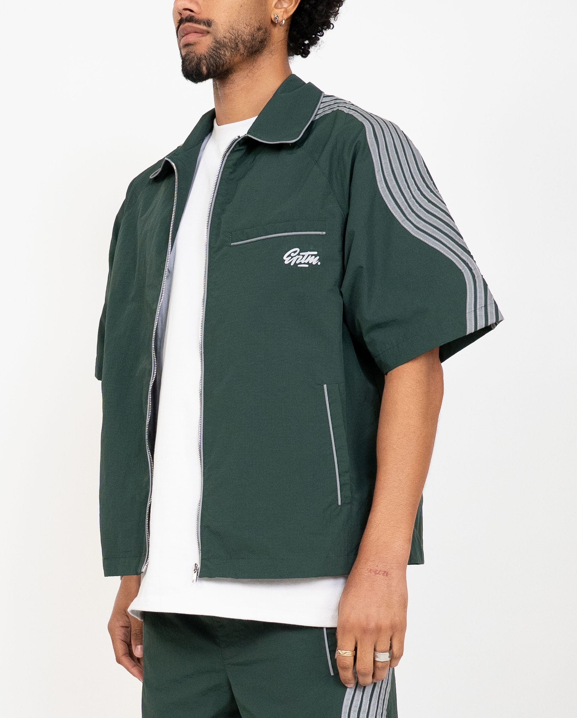EPTM Valley Set in green, a stylish matching clothing set with top and bottom pieces, displayed on a hanger against a neutral background.