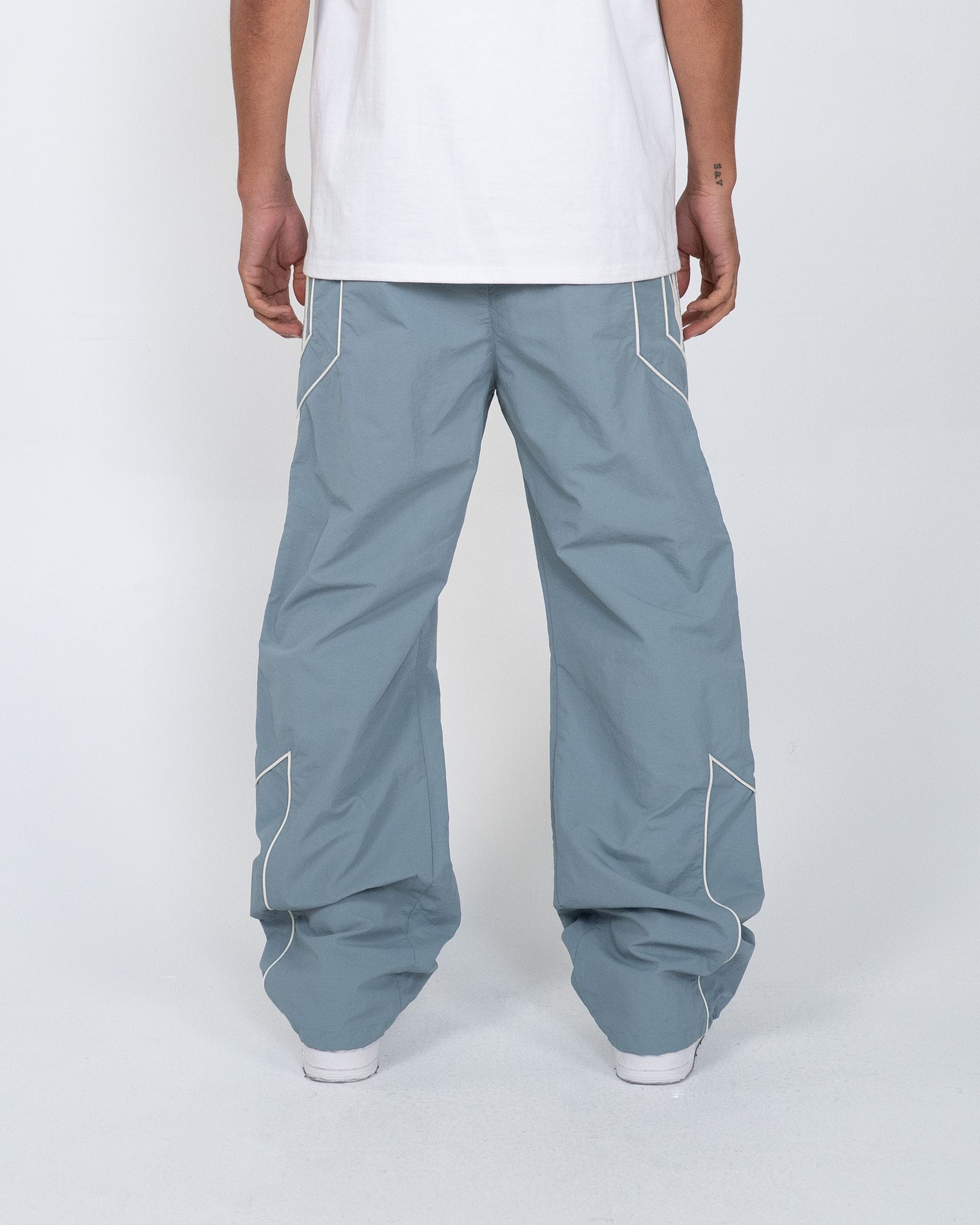 EPTM Pepe Track Pants shown in black with white logo, featuring elastic waistband and tapered fit for athletic comfort.