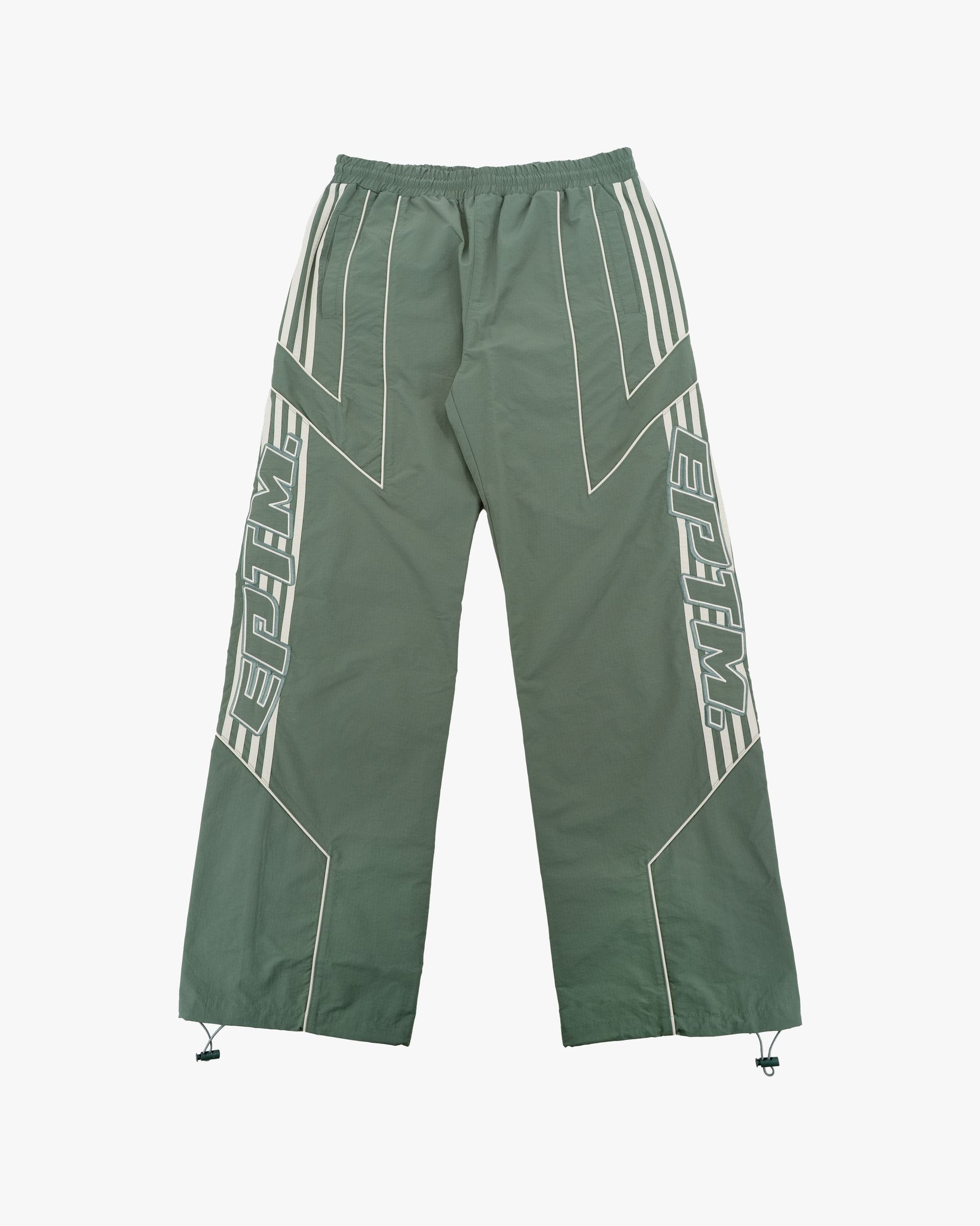 EPTM Pepe Track Pants in black, featuring a relaxed fit with elastic waistband and logo details, laid flat on a white background.