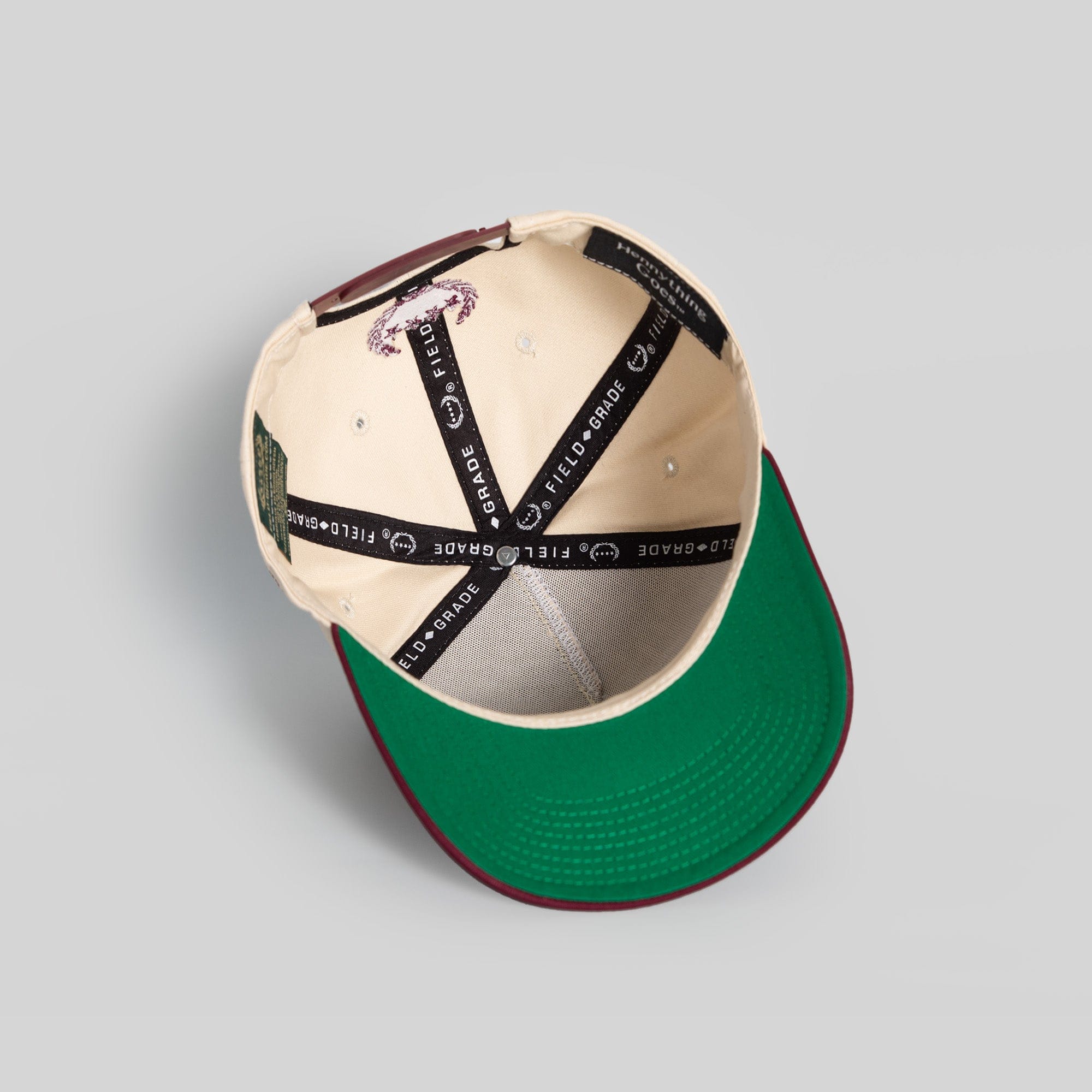Field Grade Hennything Goes Bordeaux Twill Trucker Hat featuring a classic design with adjustable strap and embroidered logo.