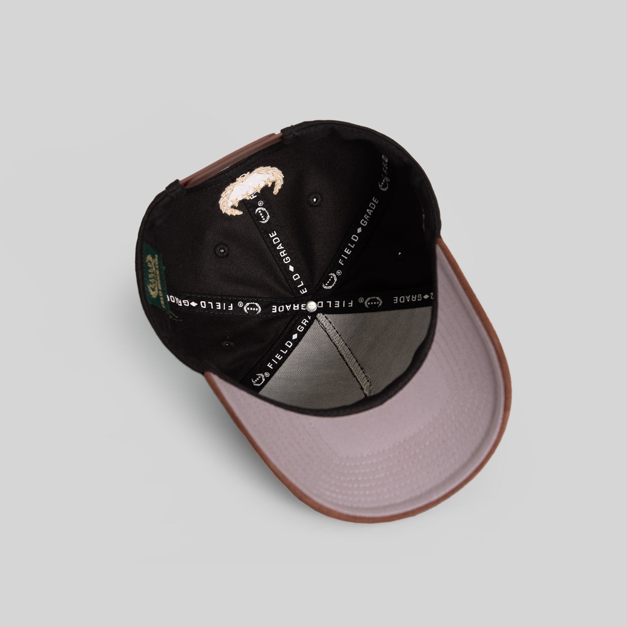 Black mocha twill and suede trucker hat by Field Grade featuring a classic structured design and adjustable snapback closure.
