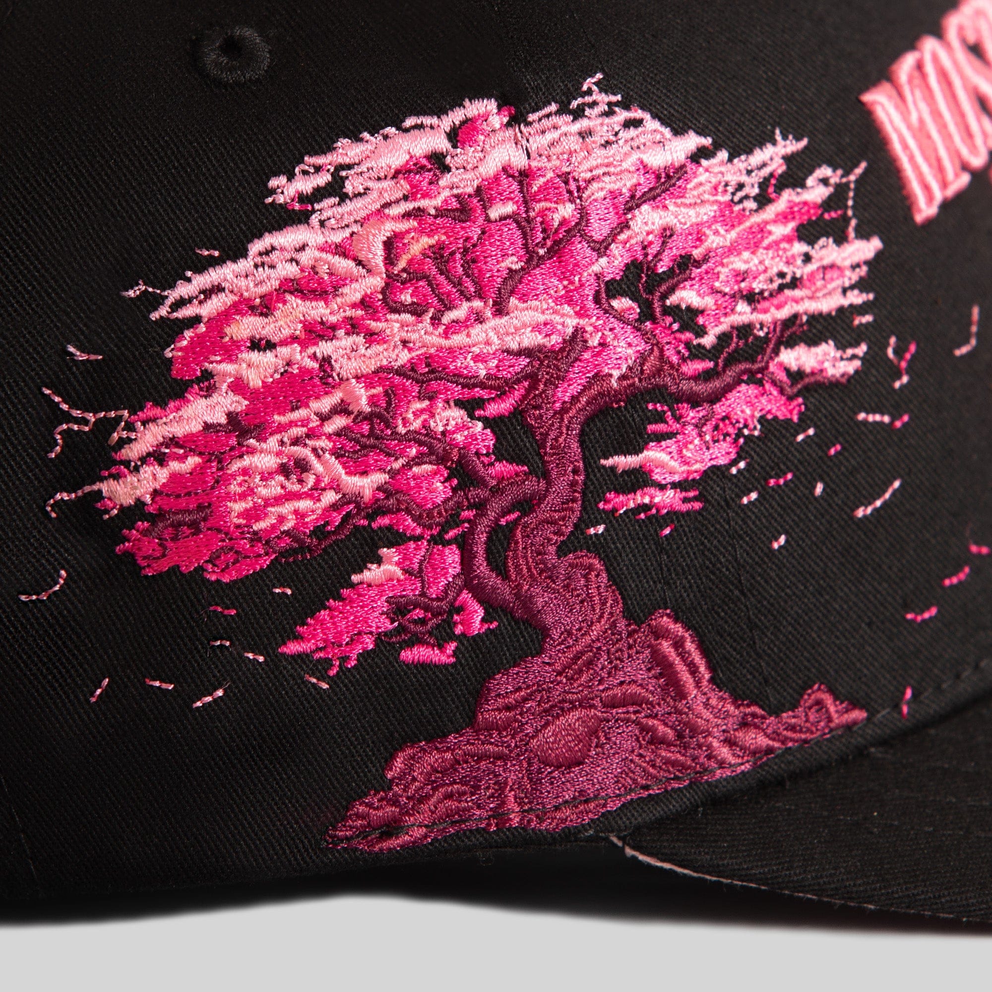 Field Grade cherry blossom black twill trucker hat with structured front and mesh back, stylish and comfortable casual headwear.