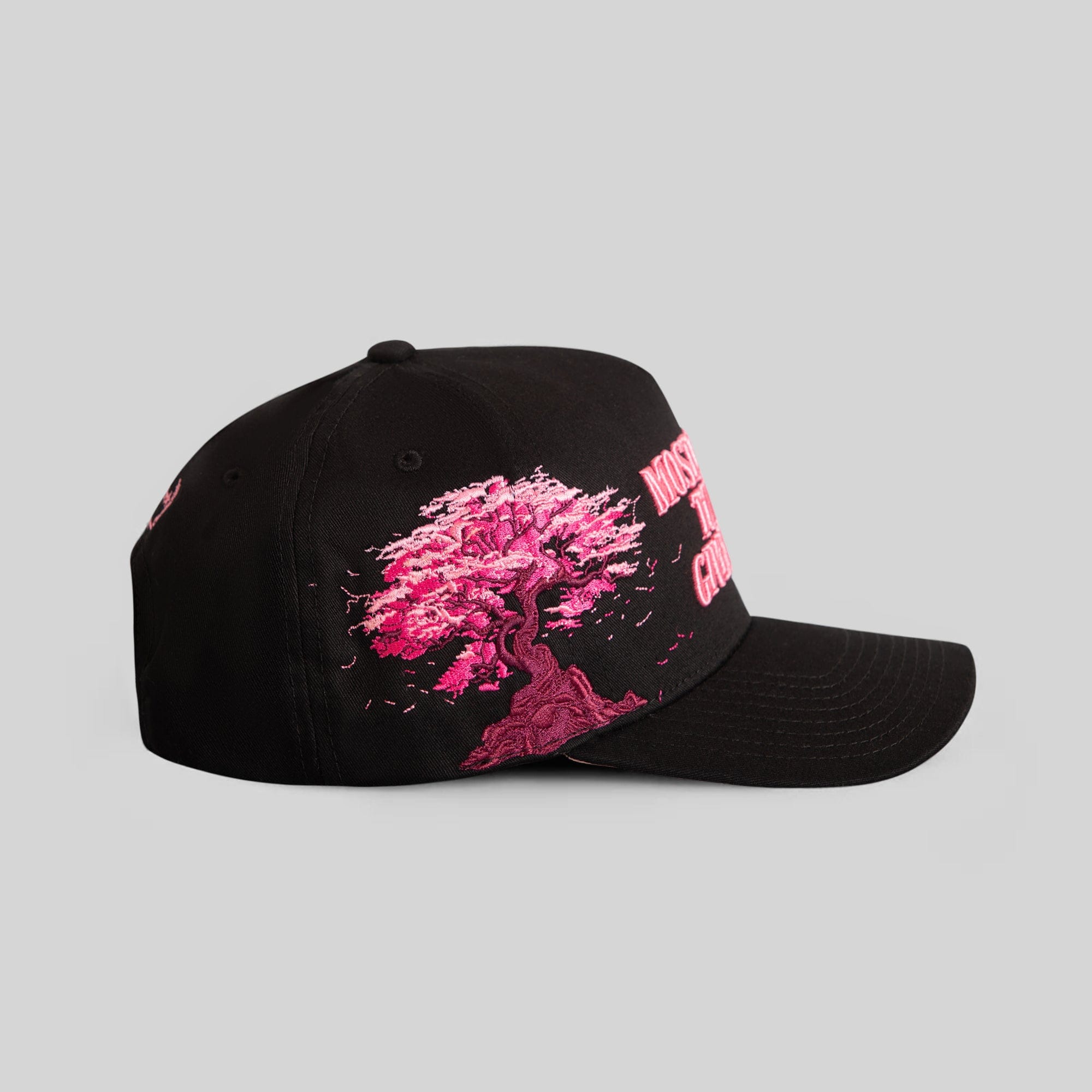Field Grade Cherry Blossom black twill trucker hat with embroidered cherry blossom design and adjustable strap.