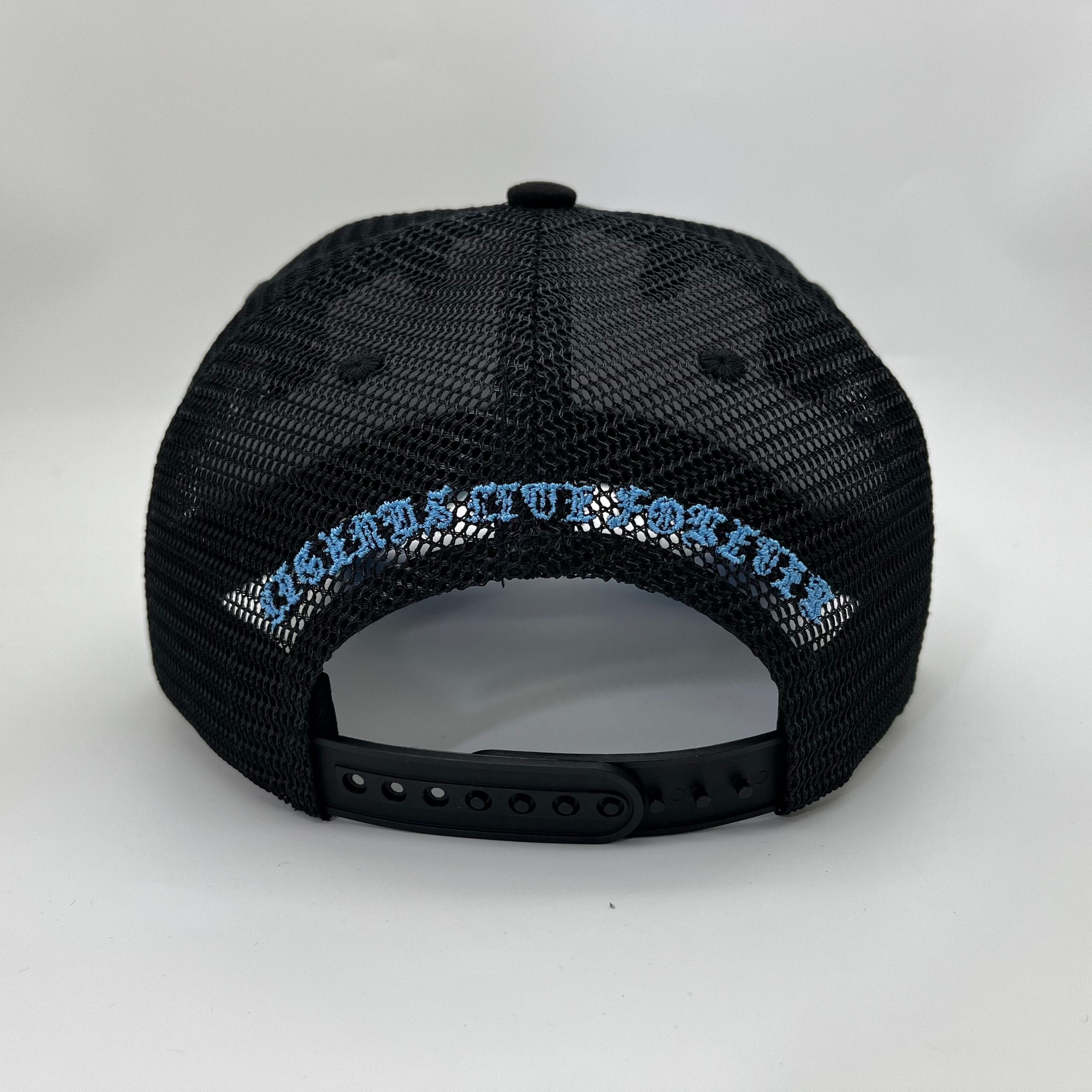 Hudson Outerwear V1 Diamond Suede Trucker Hat in black and university blue, with a curved brim and adjustable strap.
