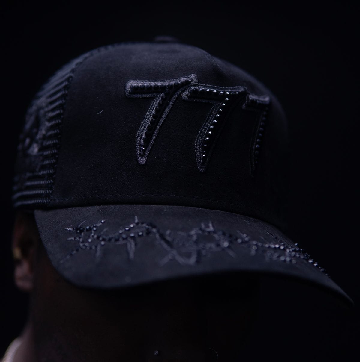 Black Hudson Outerwear V2 Diamond Suede Trucker Hat with breathable mesh panels and curved brim, stylish outdoor headwear.