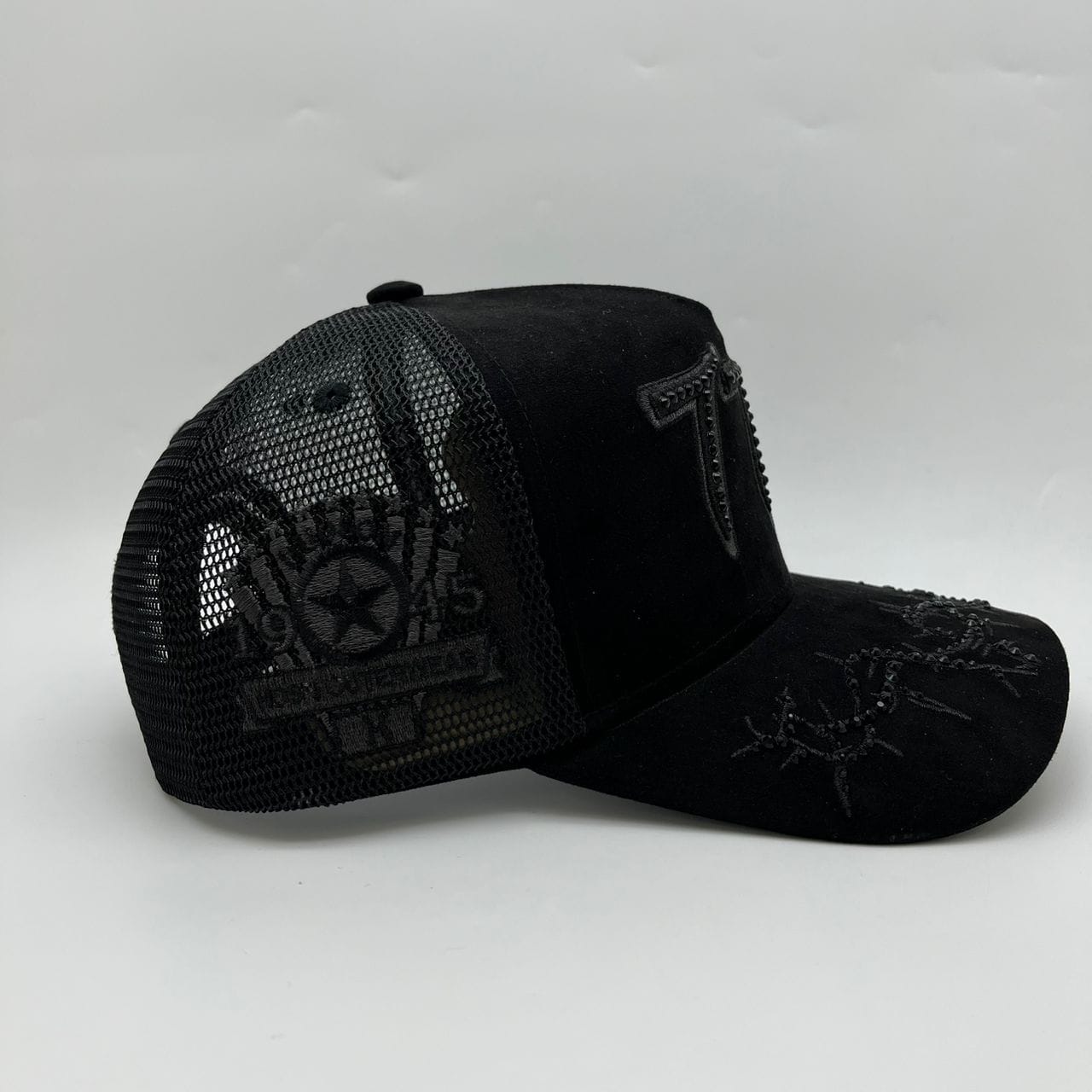 Hudson Outerwear V2 Diamond Suede Trucker Hat in black and black with a structured front and mesh back for breathability.
