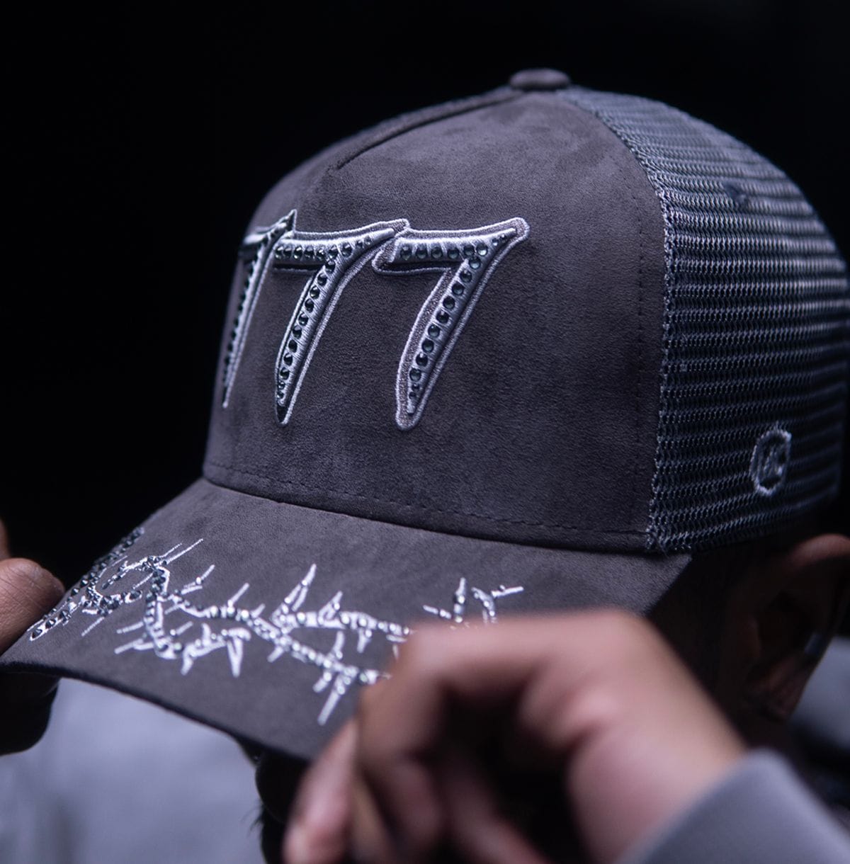 Hudson Outerwear V2 Diamond Suede Trucker Hat with curved brim and adjustable strap, featuring diamond-patterned suede fabric.