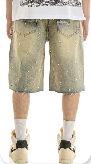KDNK rhinestone embellished denim shorts with distressed details and frayed hem, styled for a trendy casual look.