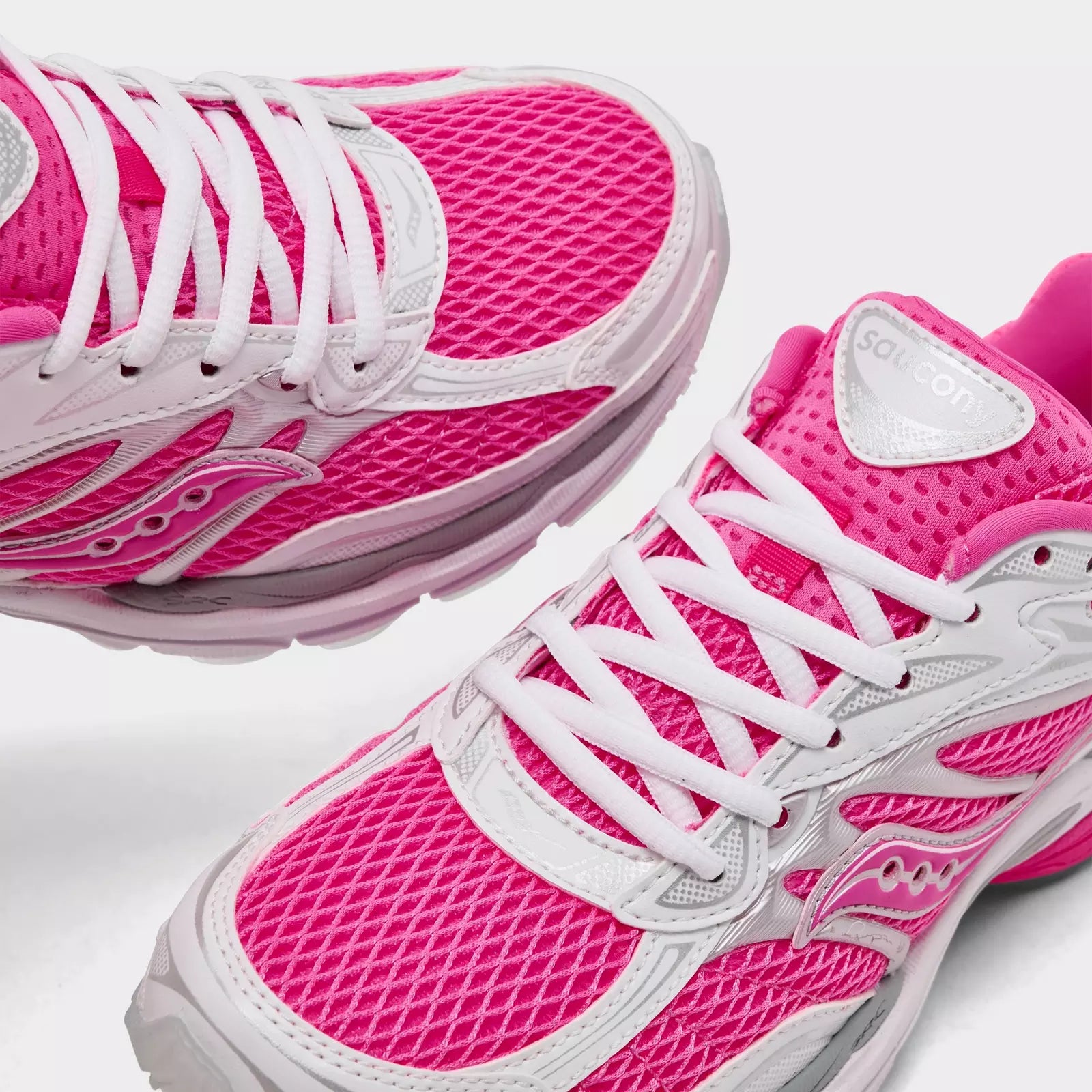Women's Saucony ProGrid Omni 9 pink sneakers with supportive design and cushioned sole, ideal for running and active wear.