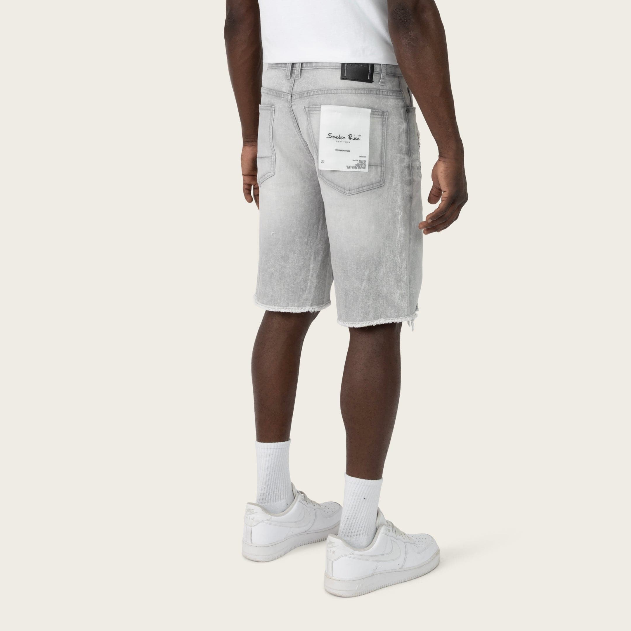 SmokeRise Essential Breezy Grey Jean Shorts, casual denim shorts with a relaxed fit and distressed details, on a model.